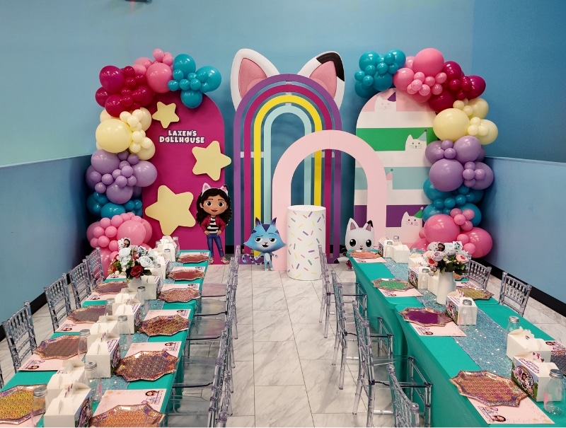 Dollhouse kids party setup with pastel decor at Kidz Kastle Warwick, RI.