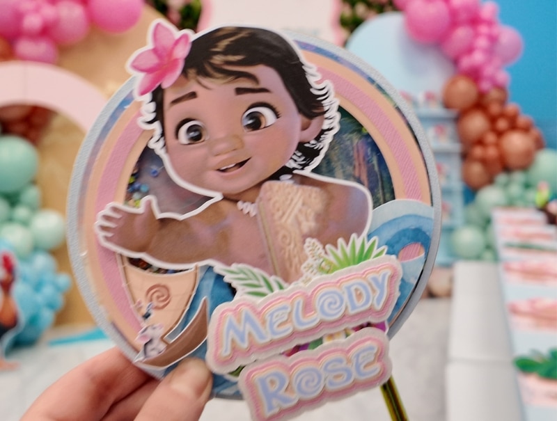 Detailed close-up of the Baby Moana cake topper from Melody Rose’s 3rd birthday party with tropical floral accents.