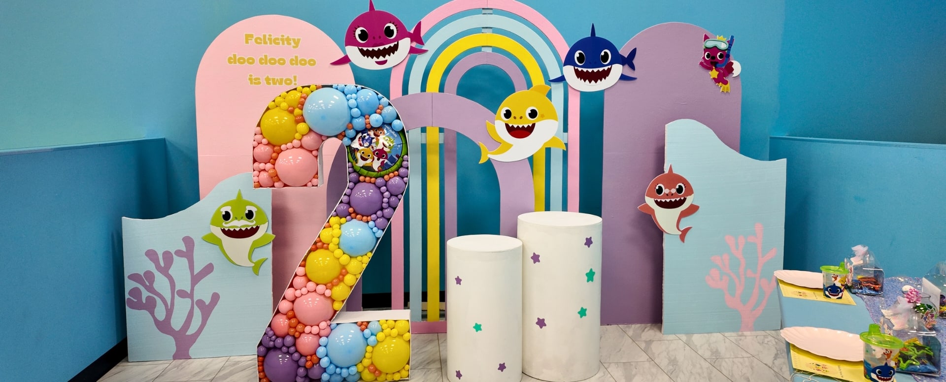 Baby Shark themed kids party room setup at Kidz Kastle in Warwick, RI, featuring colorful decorations, balloon arrangements, and party tables ready for a birthday celebration.