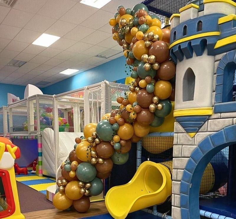 Stunning gold and green balloon garland designed for the Kidz Kastle Obstacle Course, perfect for custom party decor in Warwick, RI.