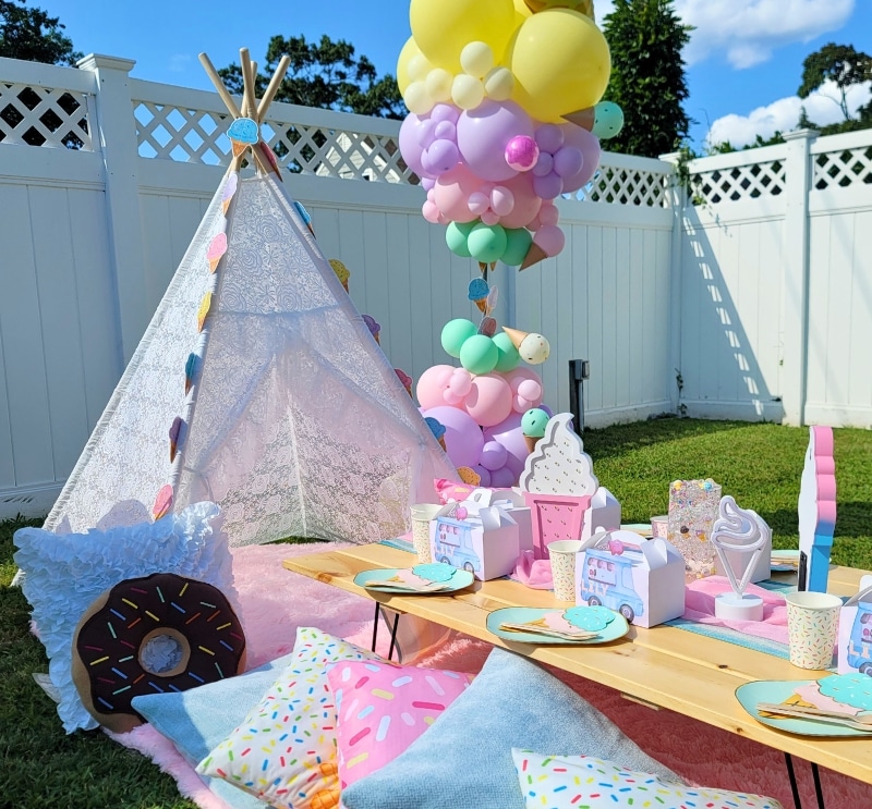 Enchanting ice cream themed magical picnic table party setup for rent, featuring vibrant decor, in Rhode Island.