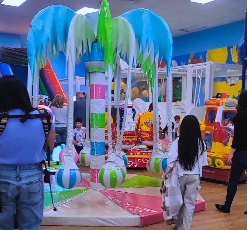 Kids and parents enjoying a fun playdate in the bright indoor playground at Kidz Kastle, Warwick RI.
