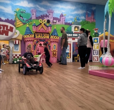 Happy children and parents enjoying a private kids birthday party in the spacious Kidz Kastle indoor playground, creating lasting memories in Warwick, RI.